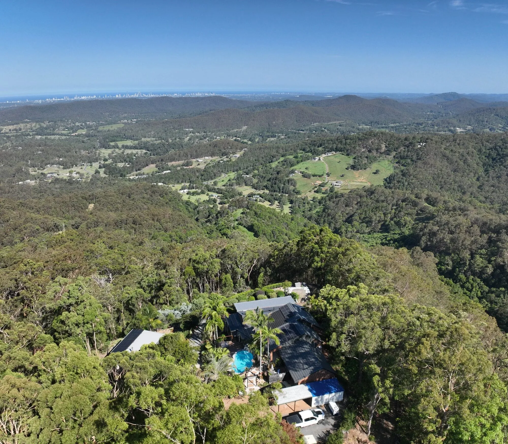 Aerial view of the forested hillside property