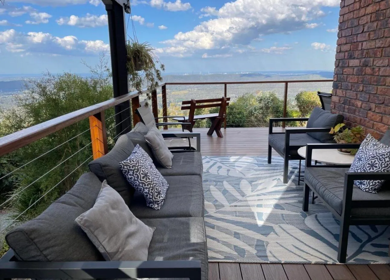 Covered deck lounge seating overlooking the treed valley