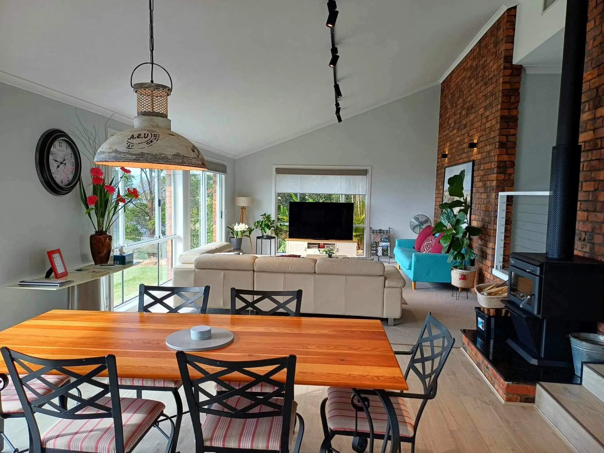 Open living and dining room with wood fire