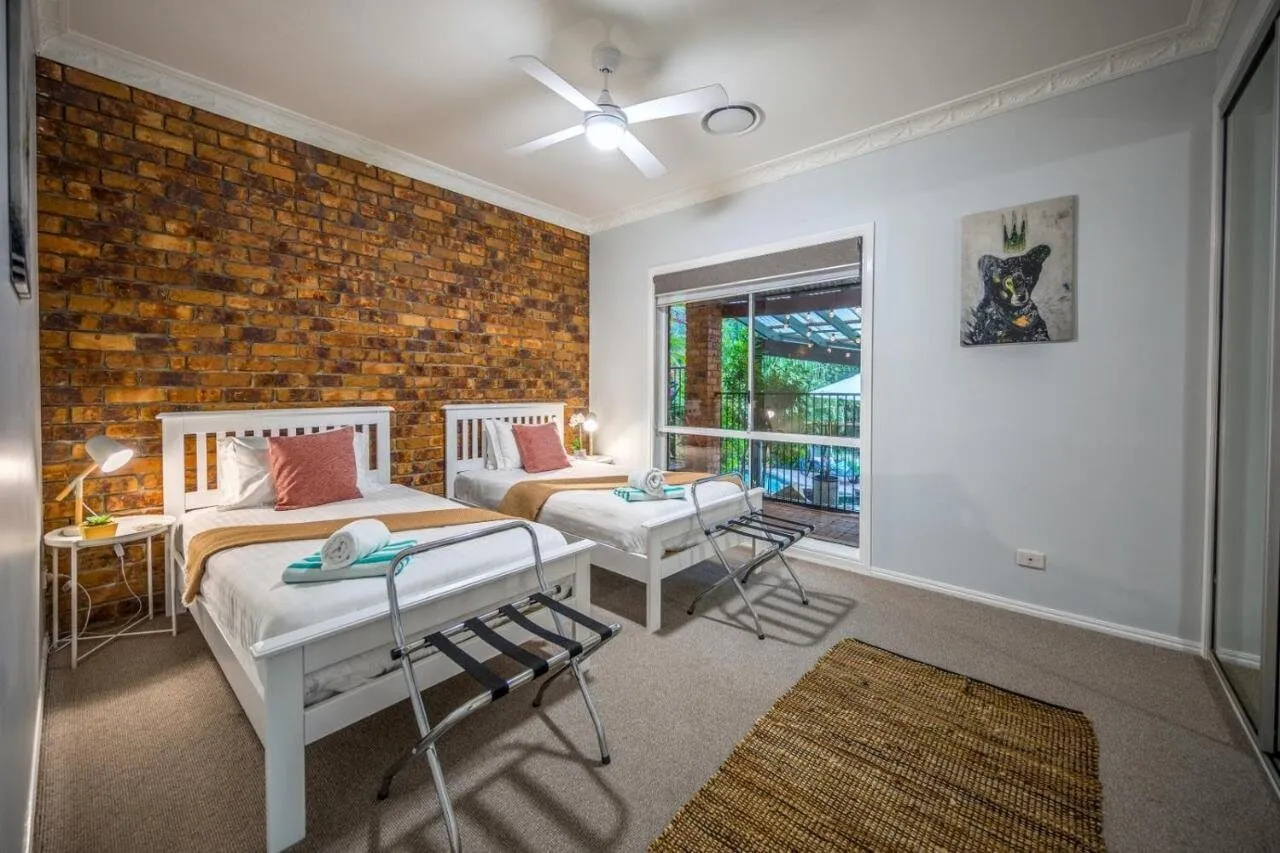 Twin bedroom with exposed brick wall