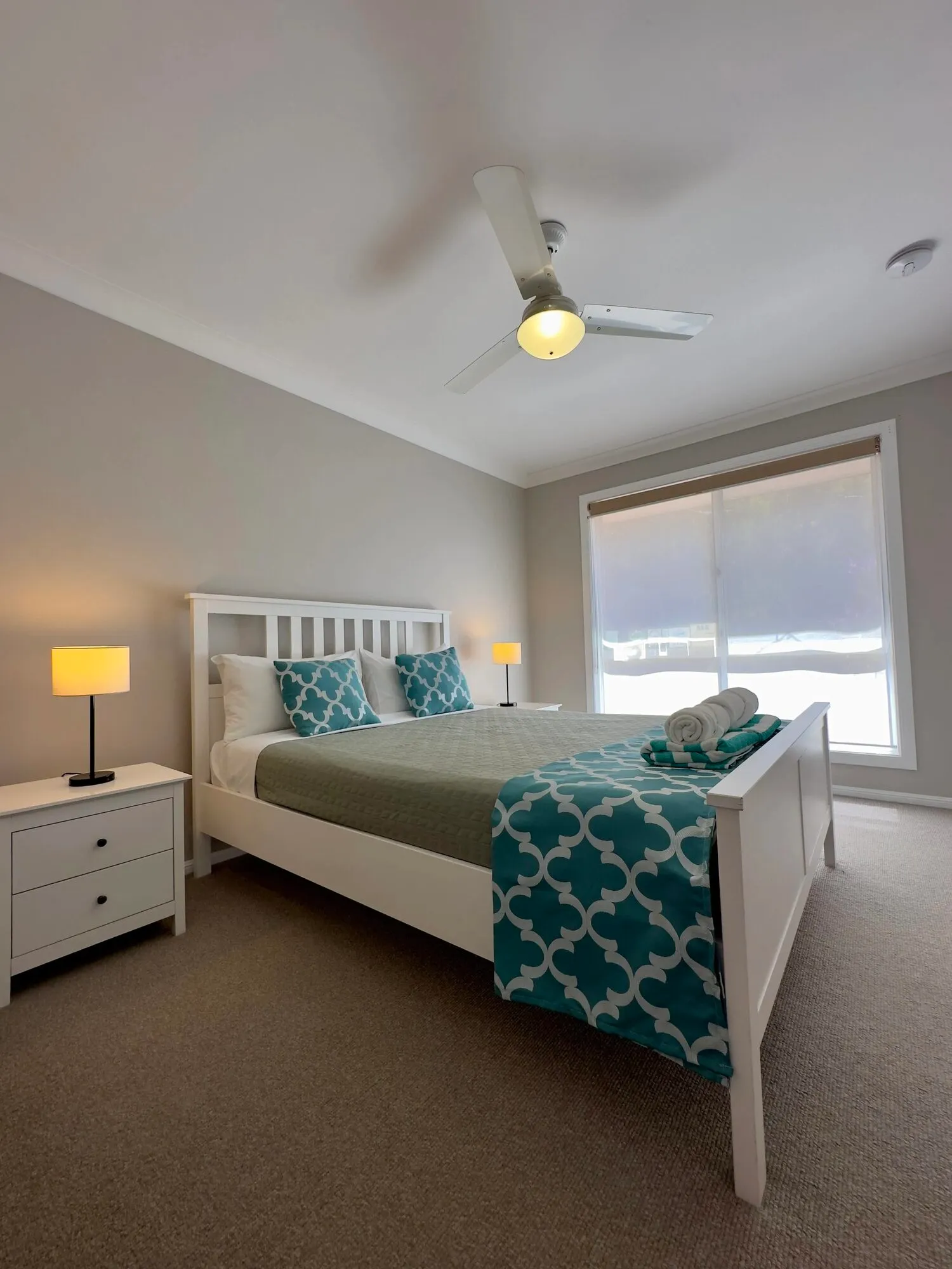 Queen bedroom with teal linen
