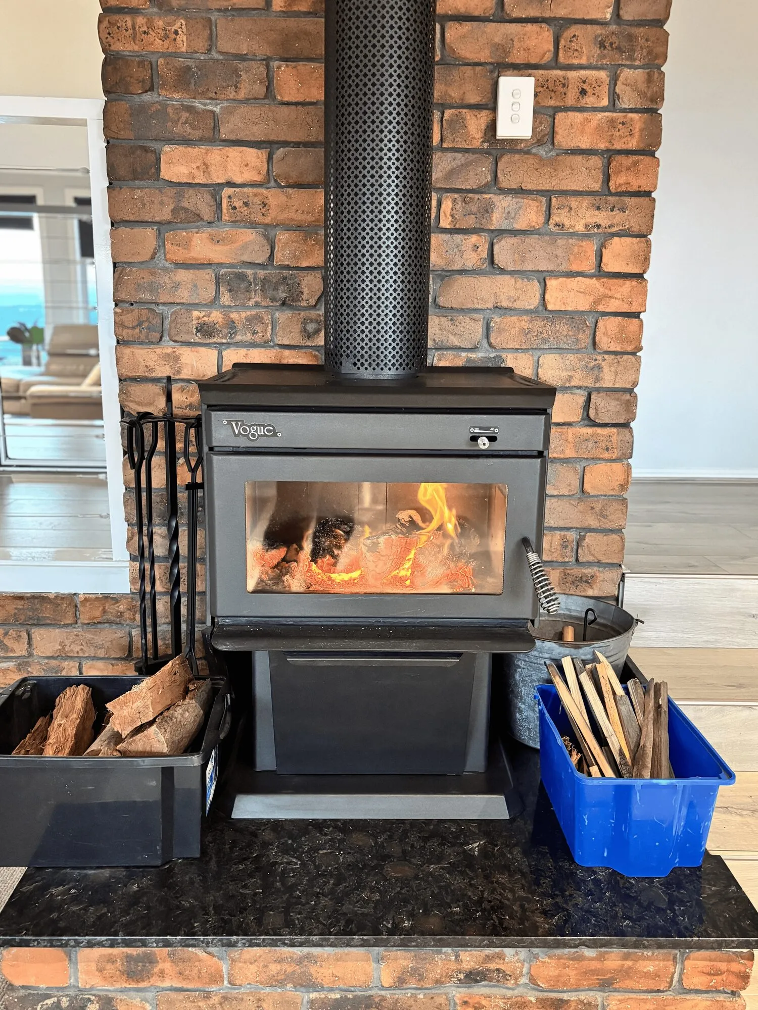 Wood fireplace burning beside the brick chimney